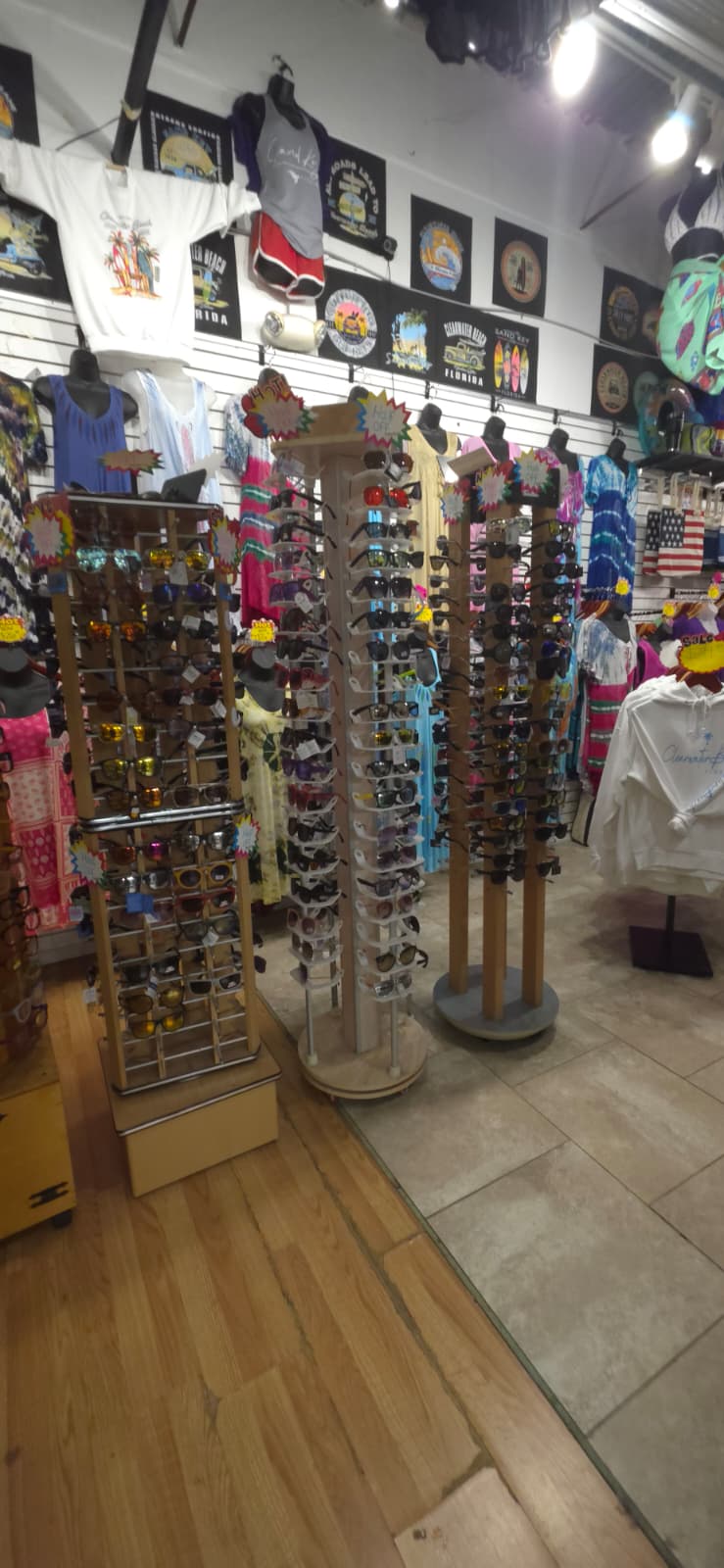 Sunglasses racks and beachwear displays inside Merry Mouse